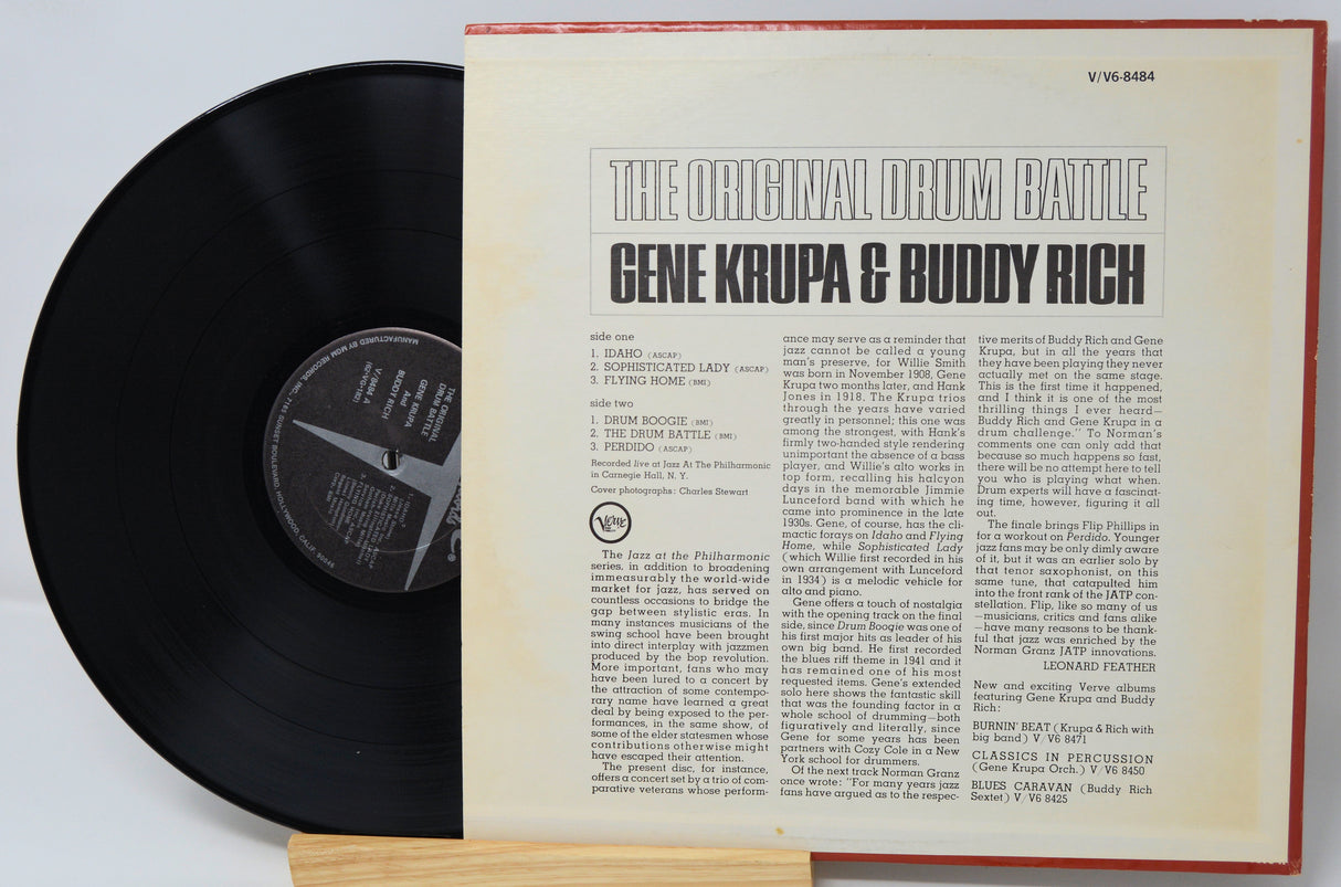 Vinyl record with cover featuring text 'The Original Drum Battle Gene Krupa & Buddy Rich' on a light gray background.