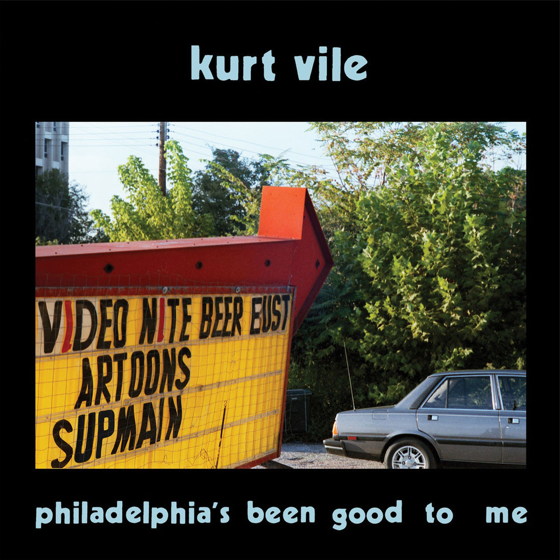 Album cover with a vintage sign and car, featuring Kurt Vile's name and album title.