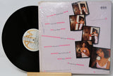 Vinyl record with a cover featuring multiple photos of a woman on a light gray background