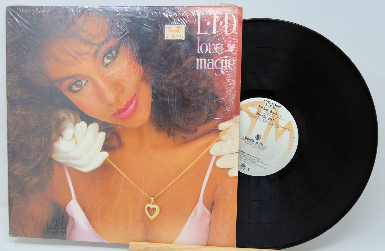 Vinyl record with a cover featuring a woman and the title 'Love Magic'.