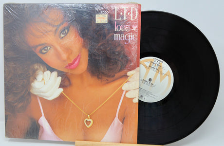 Vinyl record with a cover featuring a woman and the title 'Love Magic'.
