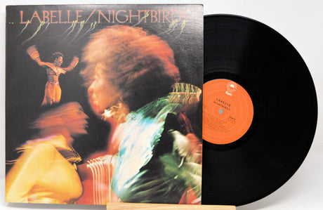 Vinyl record with cover featuring a person and colorful design, on a white background