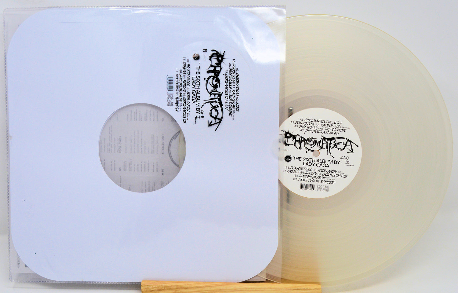 Vinyl record with a clear label and white sleeve on a white background