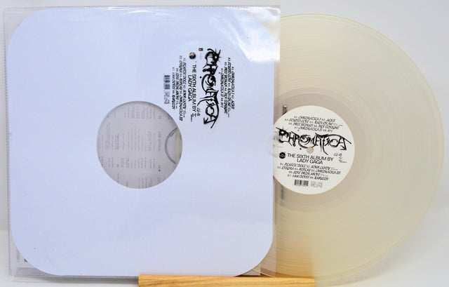 Vinyl record with a clear label and white sleeve on a white background