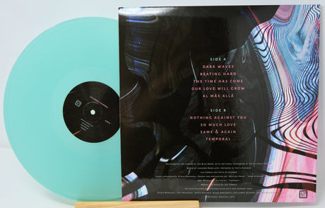 Vinyl record with a colorful cover and turquoise disc on a white background