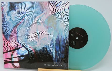 Vinyl record with a colorful cover and turquoise disc on a white background