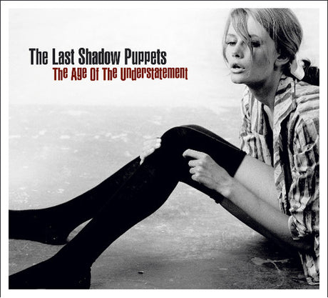 Album cover for 'The Age of the Understatement' by The Last Shadow Puppets featuring a gorgeous woman with long legs and stockings sitting on the ground.