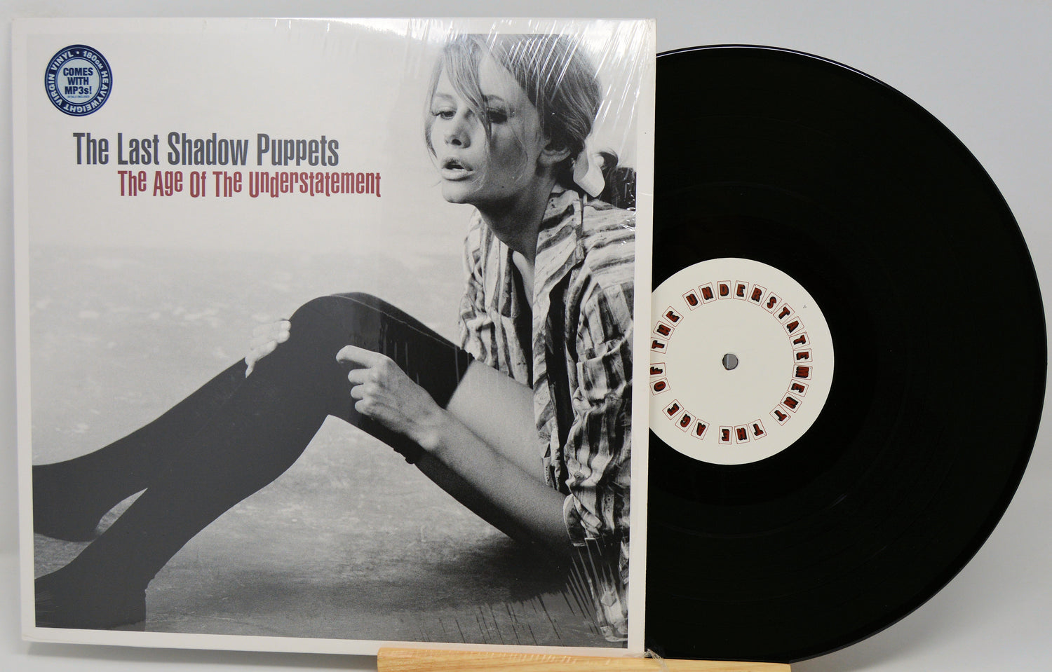 Vinyl record and cover titled 'The Age of the Understatement' by The Last Shadow Puppets.
