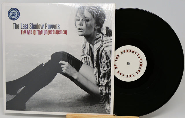 Vinyl record and cover titled 'The Age of the Understatement' by The Last Shadow Puppets.