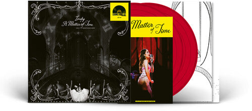 Vinyl record with red disc and black and white cover featuring a woman and cats.