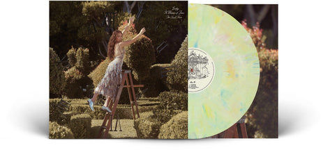 Vinyl record with a cover featuring Laufey in a garden setting on a ladder.