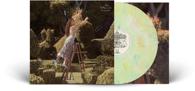 Vinyl record with a cover featuring Laufey in a garden setting on a ladder.