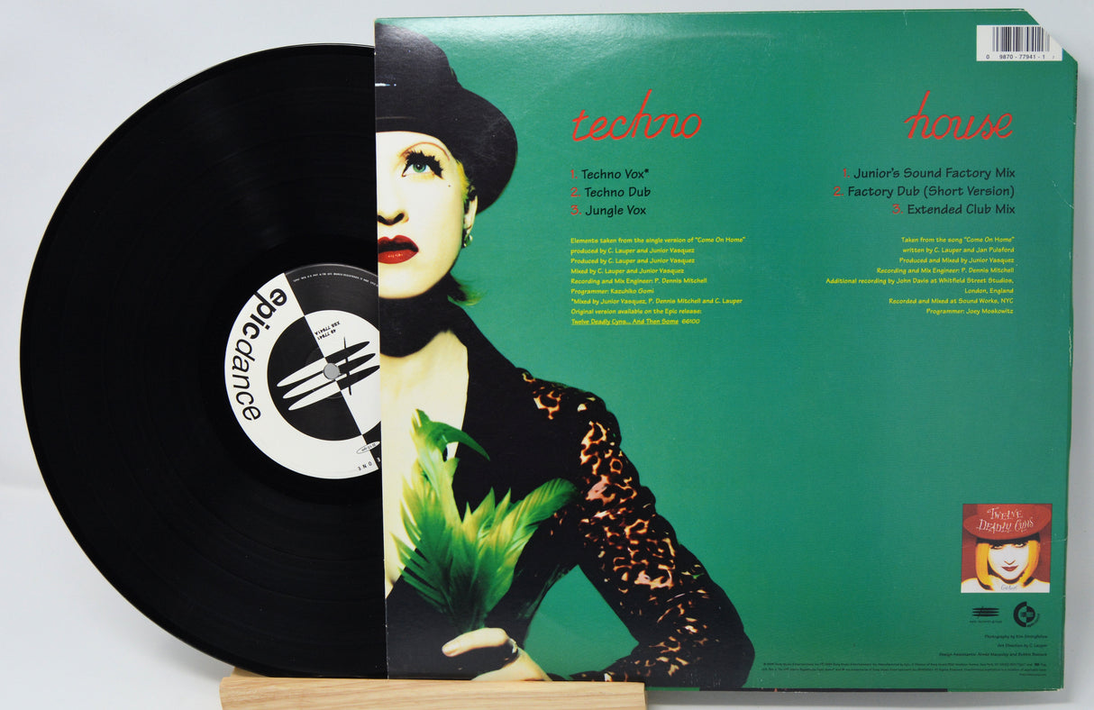 Vinyl record with a green cover featuring a person and text, on a white background.