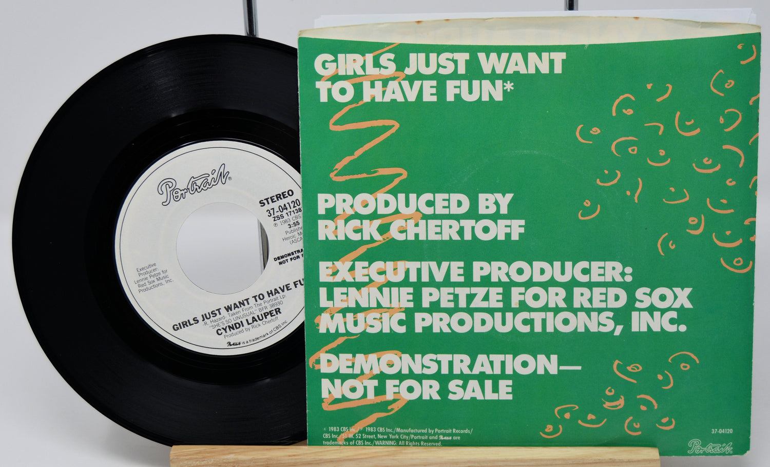 Vinyl record with green label and text on a white background