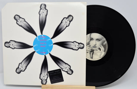 Vinyl record with artistic cover featuring a woman's face and skeleton-like design.