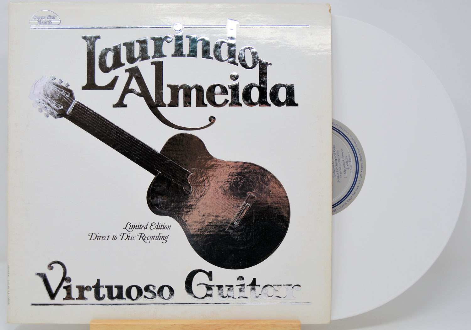Vinyl record with 'Laurindo Almeida Virtuoso Guitar' cover on a white background