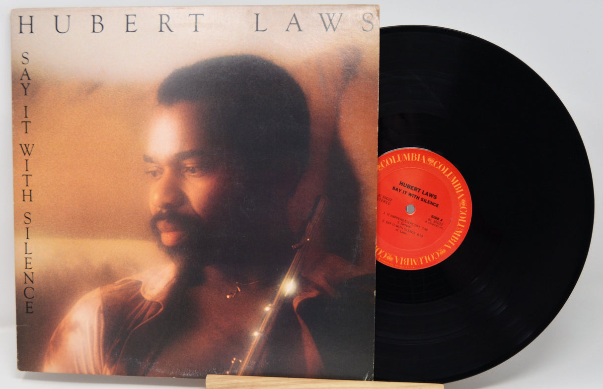 Vinyl record with cover featuring a man's portrait and album title 'Say It with Silence' by Hubert Laws.