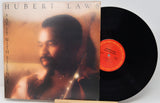 Vinyl record with cover featuring a man's portrait and album title 'Say It with Silence' by Hubert Laws.