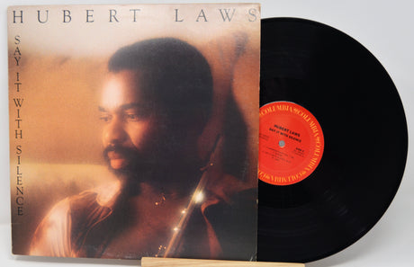 Vinyl record with cover featuring a man's portrait and album title 'Say It with Silence' by Hubert Laws.