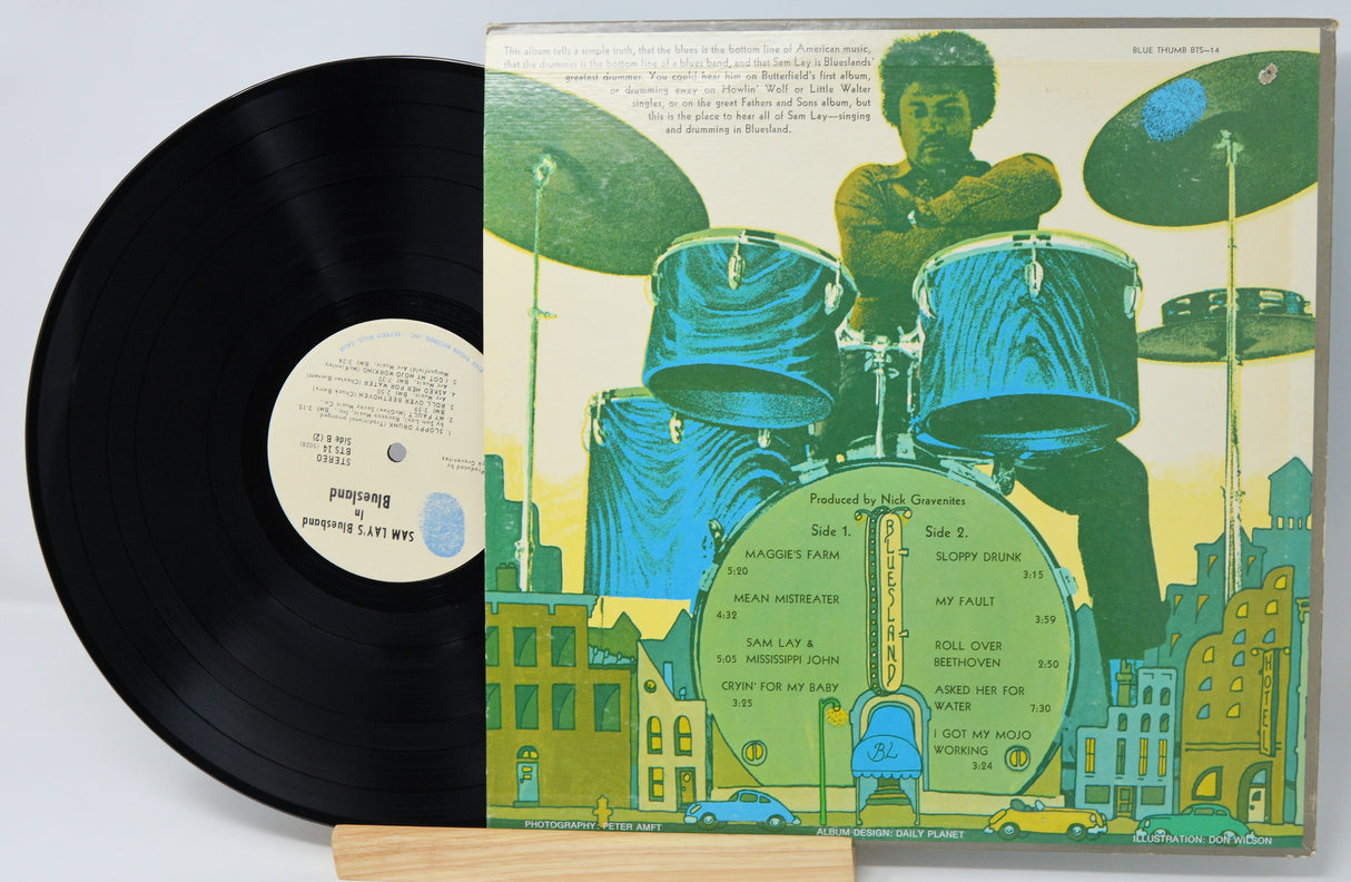 Vinyl record with a colorful cover featuring a drummer and cityscape.