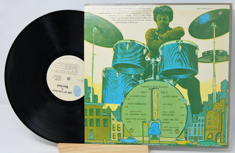 Vinyl record with a colorful cover featuring a drummer and cityscape.