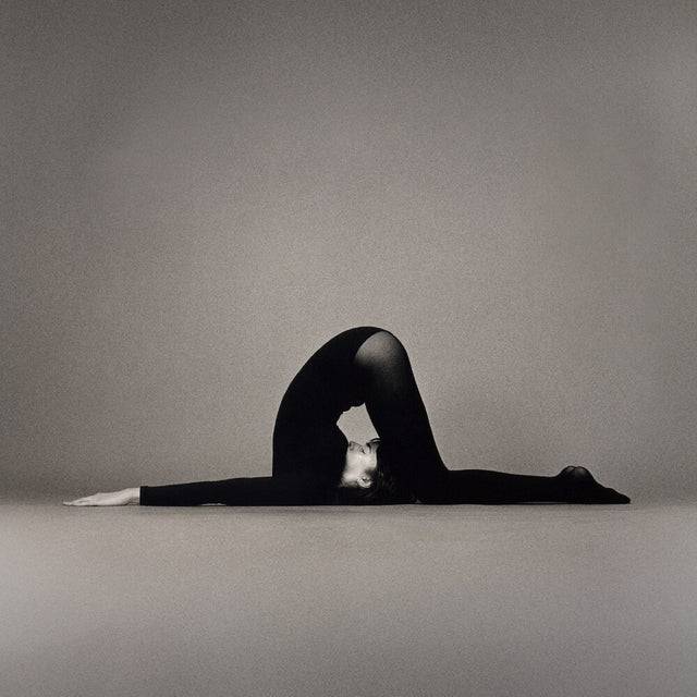 Person in a split pose on a gray background