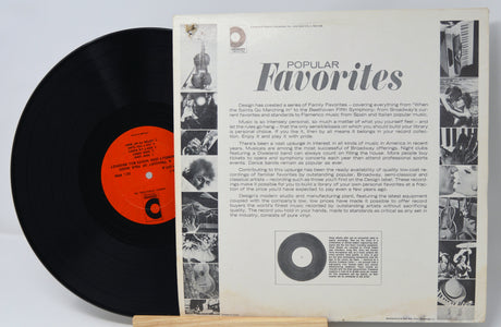 Vinyl record with a black cover and a white label featuring text and images.