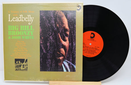 Vinyl record with cover featuring a portrait and text, on a light gray background