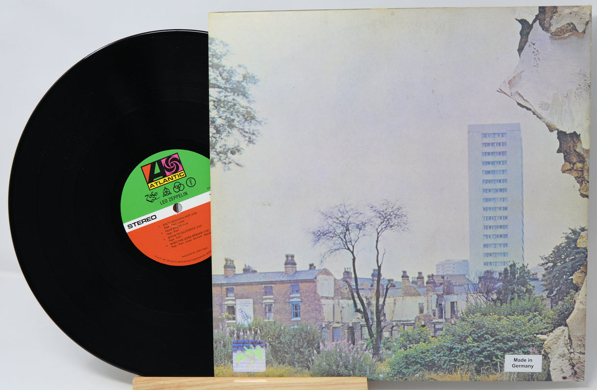 Vinyl record with a colorful album cover featuring a cityscape and trees.