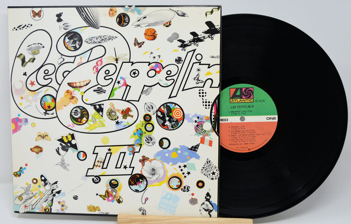 Vinyl record with a colorful cover featuring abstract designs and text.
