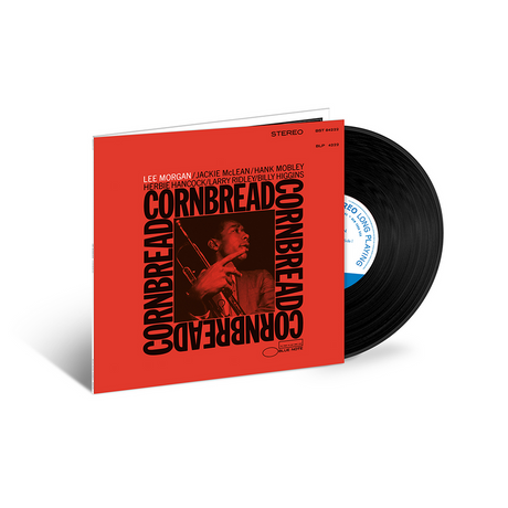 A vinyl record partially pulled from its red cover, showing the album cover for Lee Morgan's Cornbread with a black-and-red portrait and a visible black record on a clean white background.