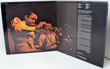 Album cover with a jazz musician playing the trumpet on one side and text on the other, on a white background.
