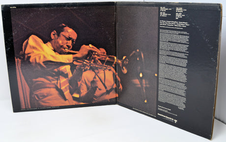 Album cover with a jazz musician playing the trumpet on one side and text on the other, on a white background.