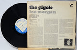 Vinyl record and cover with 'the gigolo' by Lee Morgan on a light gray background