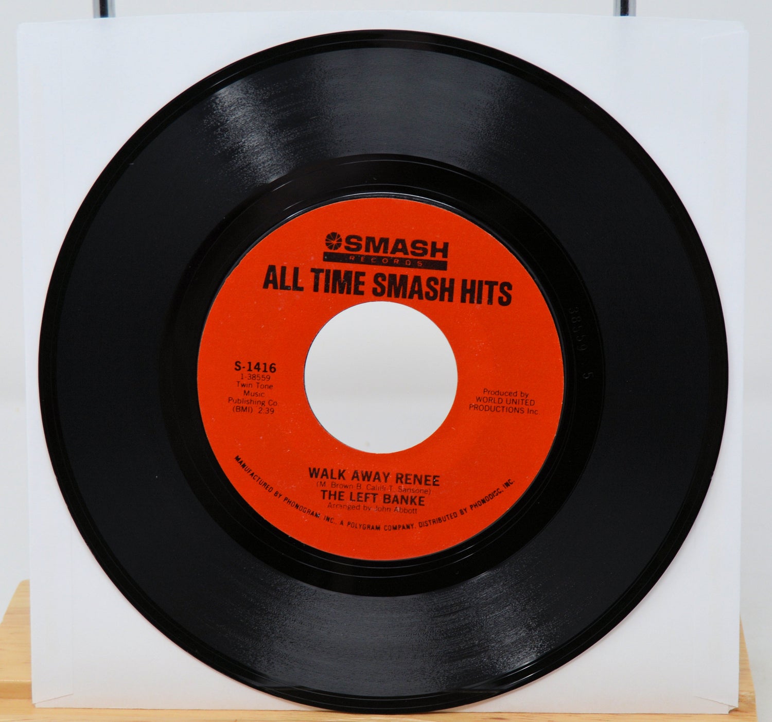 Vinyl record with red label on a white background
