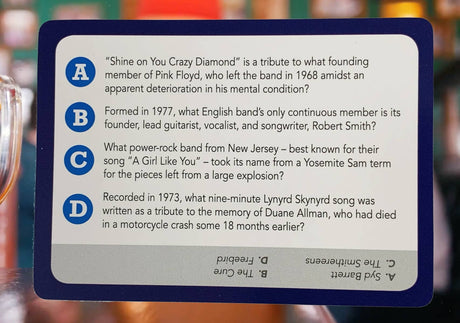 Trivia card with questions about legendary rock musicians and classic songs