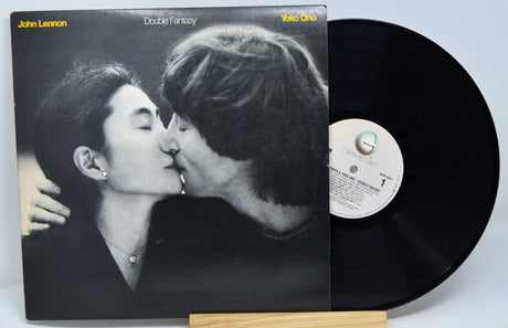 Vinyl record with cover showing a couple kissing, on a white background