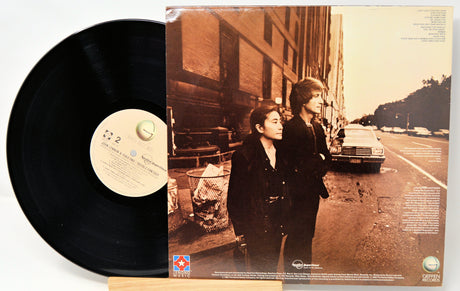 Vinyl record with a cover featuring two people on a street.