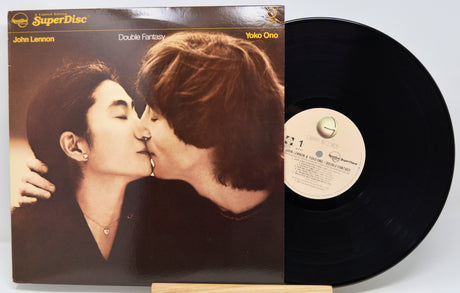 Vinyl record with cover featuring a couple kissing, on a white background