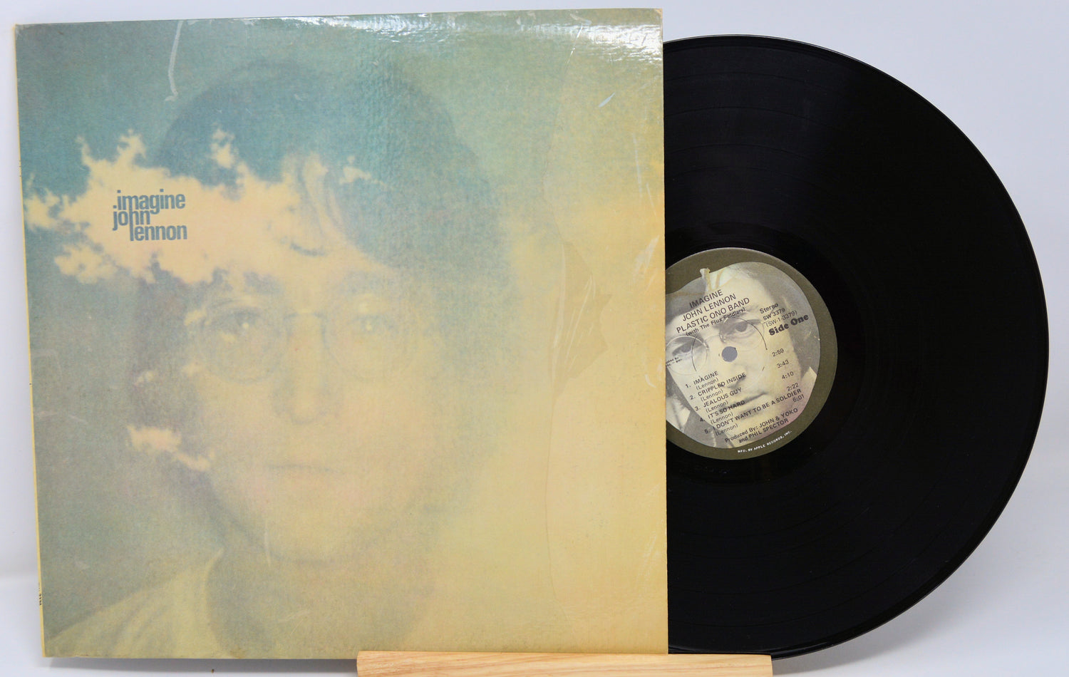 Vinyl record with cover featuring a face and 'Imagine Peace' text on a white background