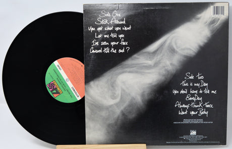 Vinyl record with a black cover featuring a black and white image and text.