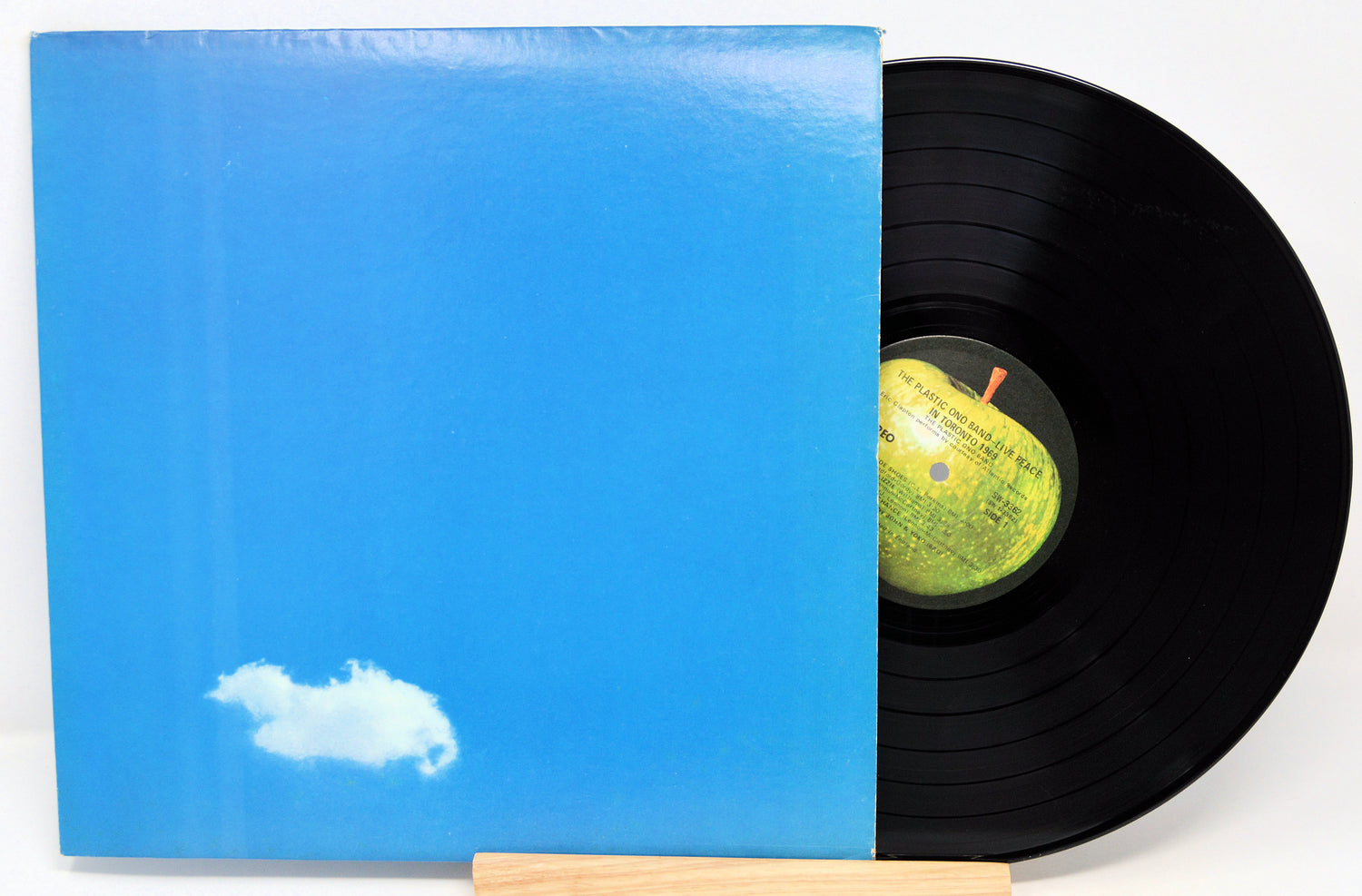 Vinyl record with blue cover and white cloud design on a white background