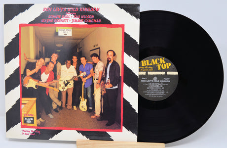 Vinyl record with cover featuring a group of people and text on a black and white striped background