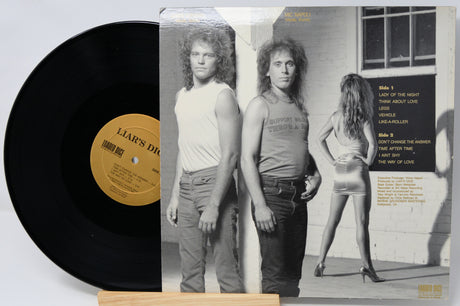 Vinyl record with cover featuring a black and white photo of two people and a woman.