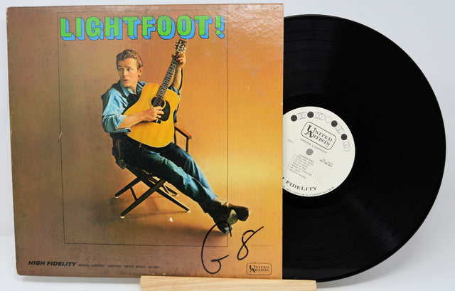 Vinyl record with cover featuring a person playing guitar, on a white background