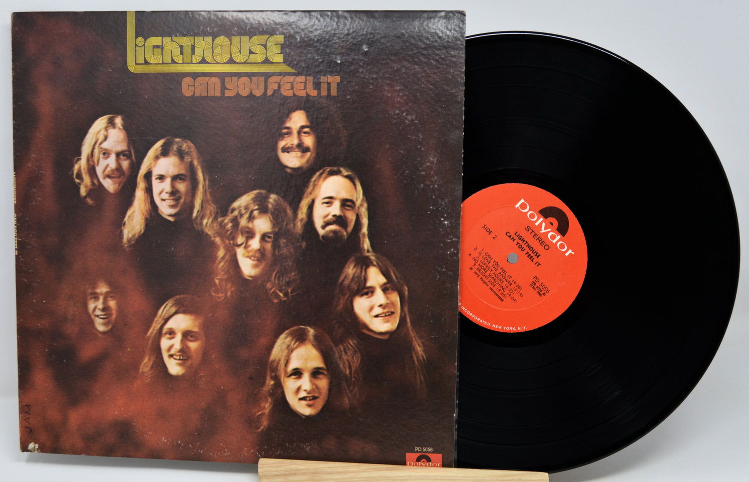 Lighthouse - Can You Feel It vinyl record LP with the album cover sleeve and a black vinyl record partially pulled out, showing the orange label.