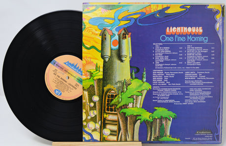 A vinyl record partially pulled from its album jacket, showing the black record on the left and the colorful back cover on the right. The cover features the title 'Lighthouse One Fine Morning' with a whimsical illustrated tower and landscape on a purple background.
