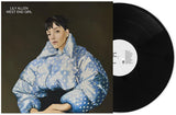 Vinyl record with a cover featuring a person in a blue polka dot jacket, titled 'West End Girl' by Lily Allen.