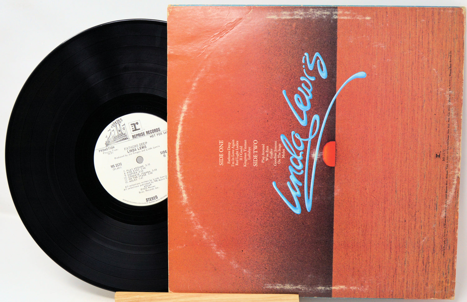 Vinyl record with orange cover featuring a signature and text
