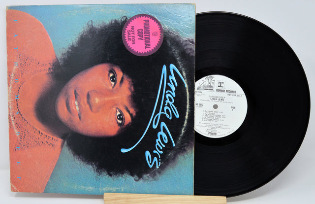 Vinyl record with a colorful cover featuring a person's face and the title 'Little Wings' on a white background.